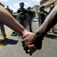Holding hands in front of a police line in Baltimore. (Reuters//Jim Bourg)